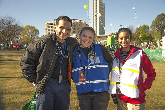Spotters—usually medical students and EMTs—are stationed at checkpoints along the Publix Georgia Marathon route to update Lekshmi Kumar (above, right) about runners in trouble. She leads operations from the medical tent at Centennial Olympic Park. 