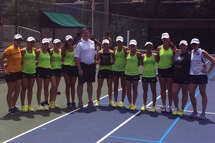 The Emory women's tennis team poses together after claiming its fifth consecutive UAA title.