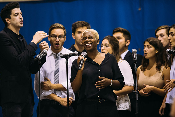 A choral group performs on the stage.