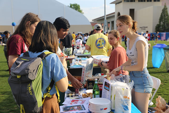 Students eat food at the ISLAB International Festival.