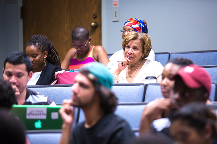 Cynthia Neal Spence, director of UNCF/Mellon programs, sits in the audience as students participate in the roundtable discussion.