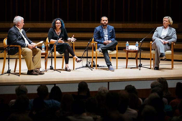 Kevin Riley, Brooke Gladstone, Wesley Lowery and Carolyn Ryan sit in chairs on the stage of the Decatur Book Festival keynote.