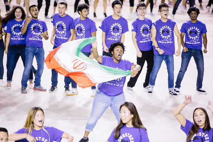 A student performs with a flag at Songfest