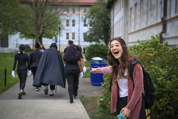 A student points excitedly at Dooley making her away around campus