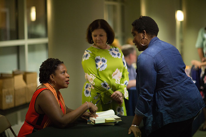 Tayari Jones speaks with an audience member individually after the discussion.