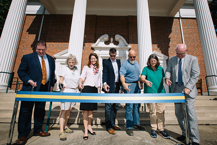 Several Emory community members cut a ribbon with scissors