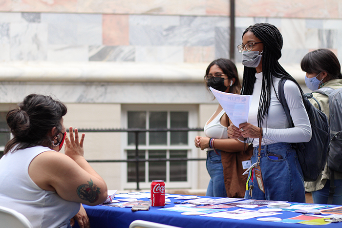Students receive information at a table