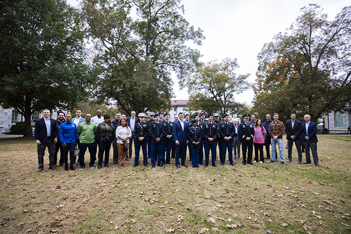 A large group of members of the military community gather for a photo