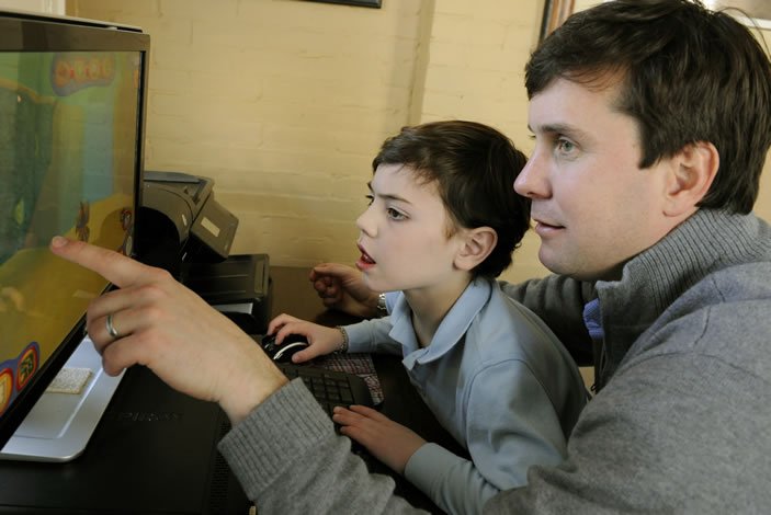 Father and son working at a computer