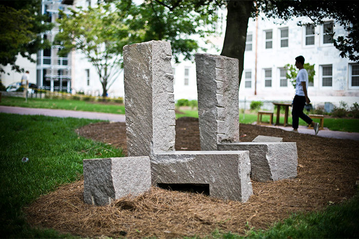   "Stone Grove" resides in the green area between Cox Hall and Dobbs University Center. Environmental sculptor Richard Nonas trained as an anthropologist and takes a minimalist philosophy in producing his works