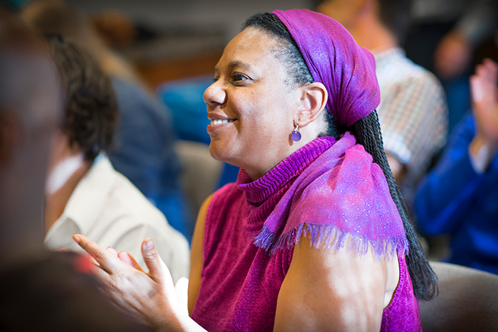 An audience member applauds at the "Neil Asks" event.