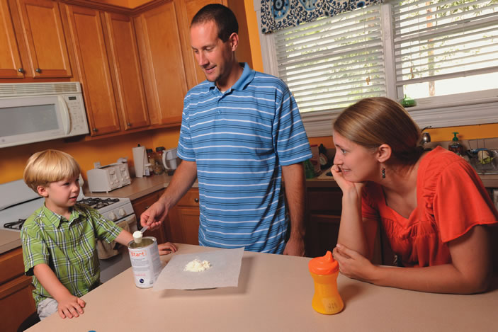 Ryan and Stephanie Harry with their son Christopher in the famiy kitchen