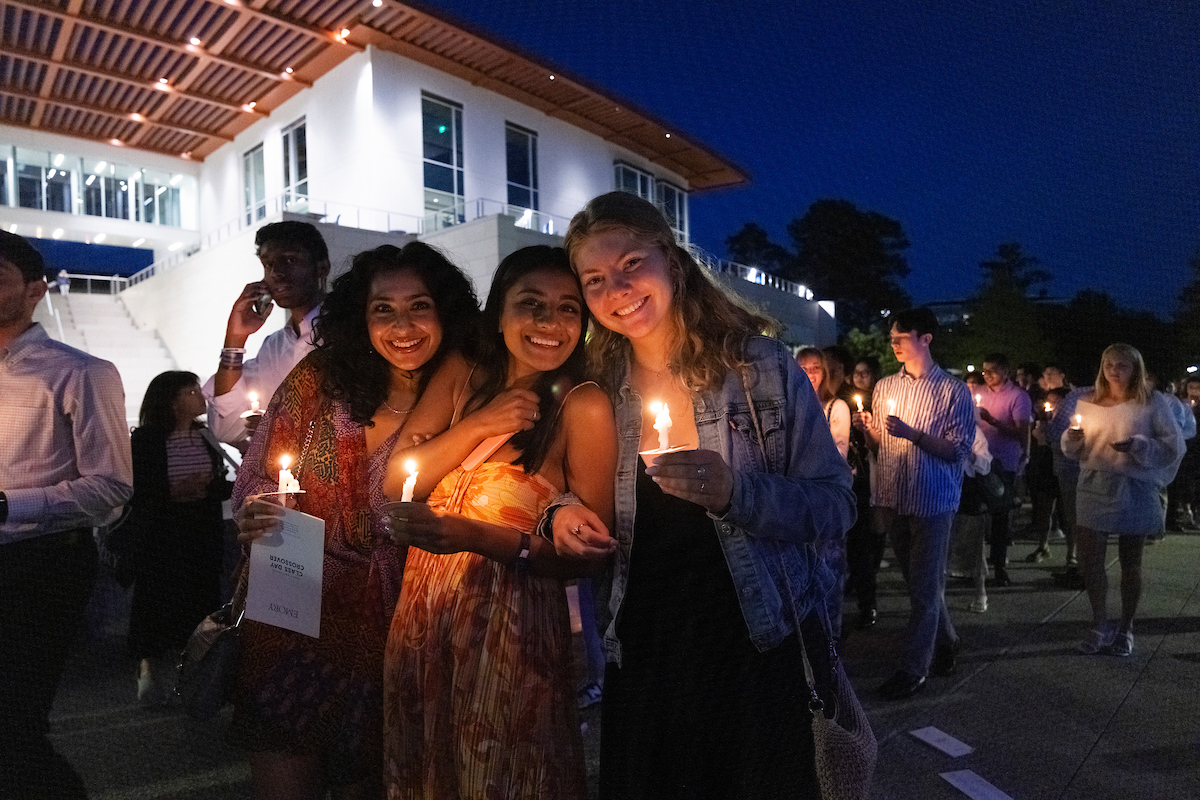 Students hold their lit candles during the Crossover.