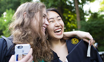 Two Emory students pose at graduation