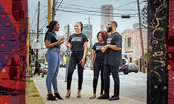 A group of students talks on the streets of Atlanta, wearing Black Lives Matter t-shirts