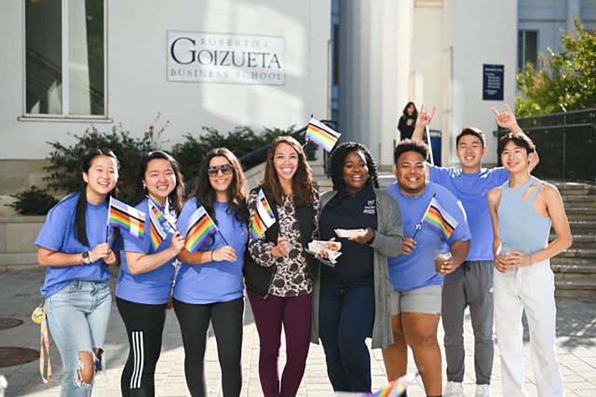 Students in front of Goizueta holding pride flags