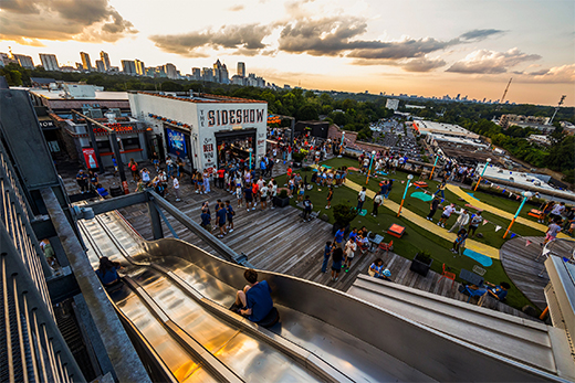 people playing games on rooftop event area