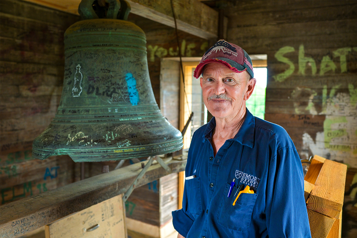 Photo of Gourley smiling and standing in the graffitied Clock tower
