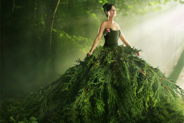 Getty stock image of a woman wearing a green dress in a forest