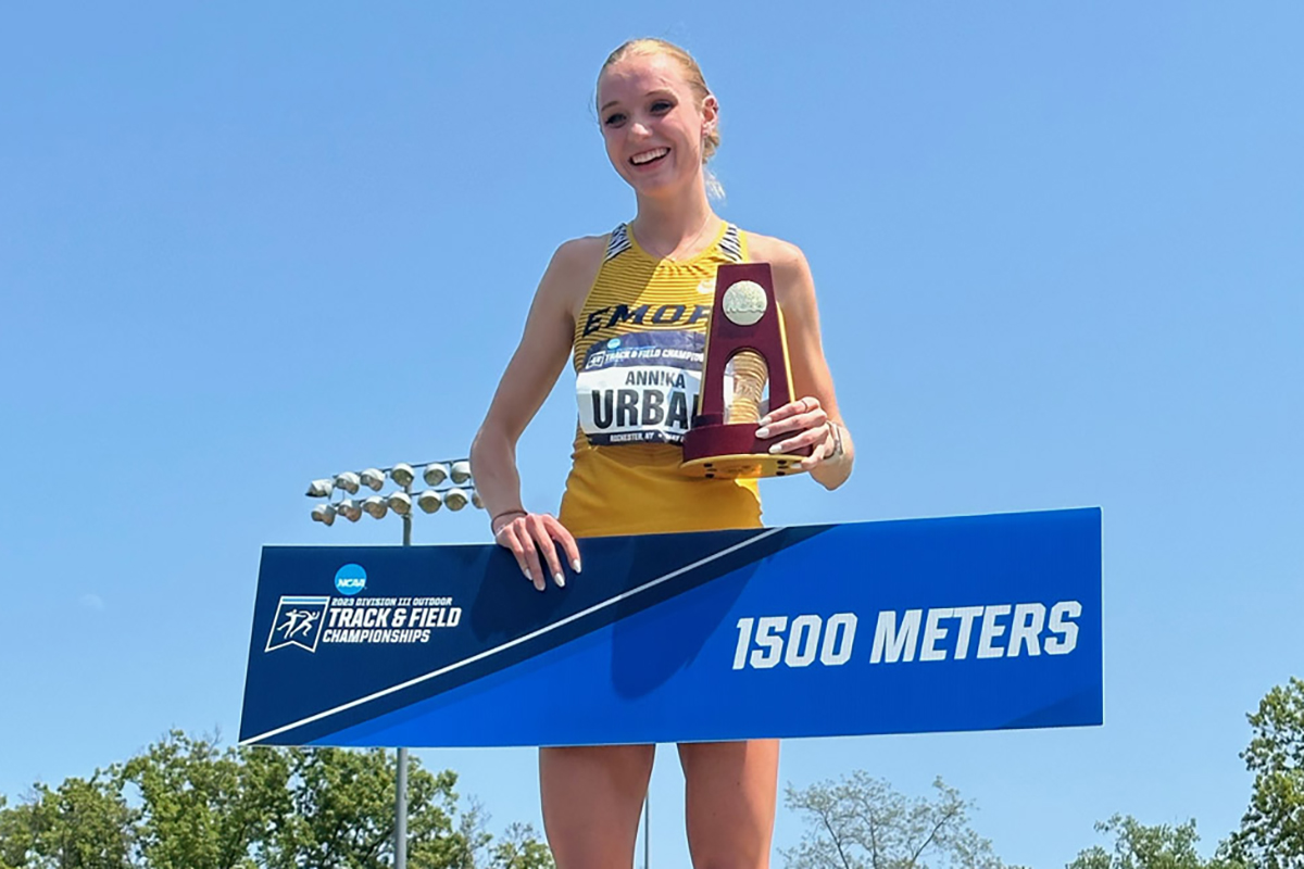 student Annika Urban on podium holding trophy and a 1500 Meters sign