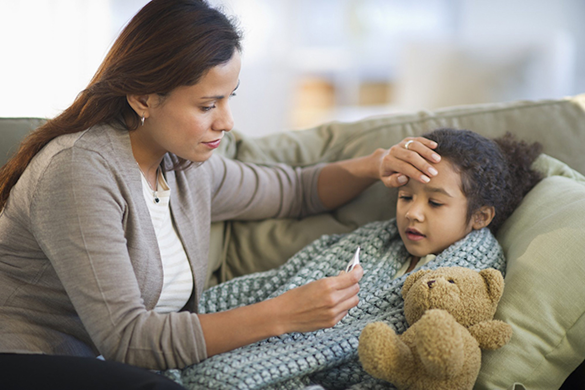 Mother taking the temperature of an ill child