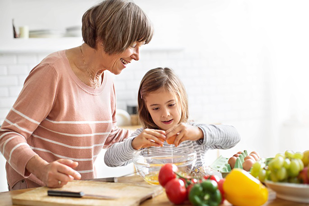 Grandmother and granddaughter cooking together