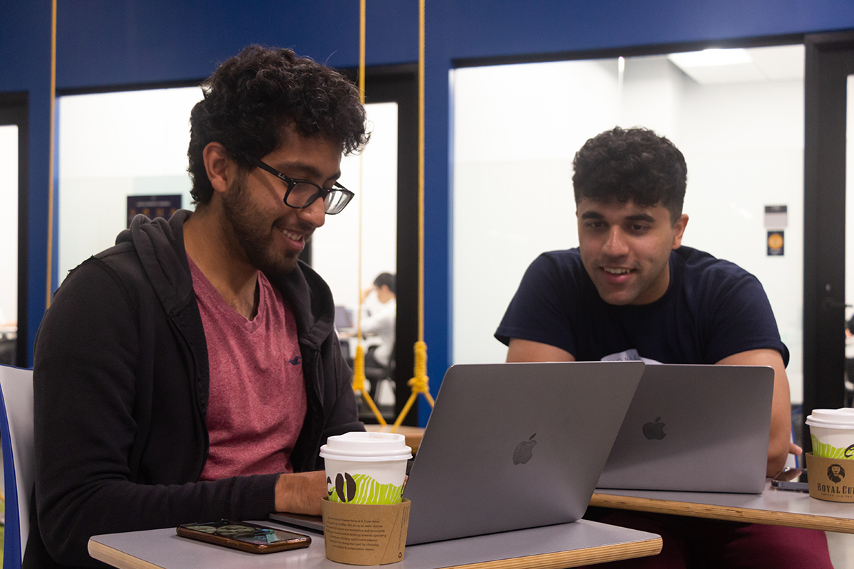 Two students work together on laptops at The Hatchery