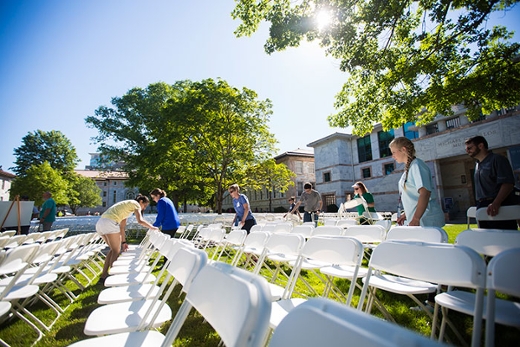 rows of white chairs on Emory University Quadrangle