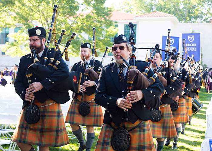 The Atlanta Pipe Band leads the procession at the start of Emory&#39;s Commencement.