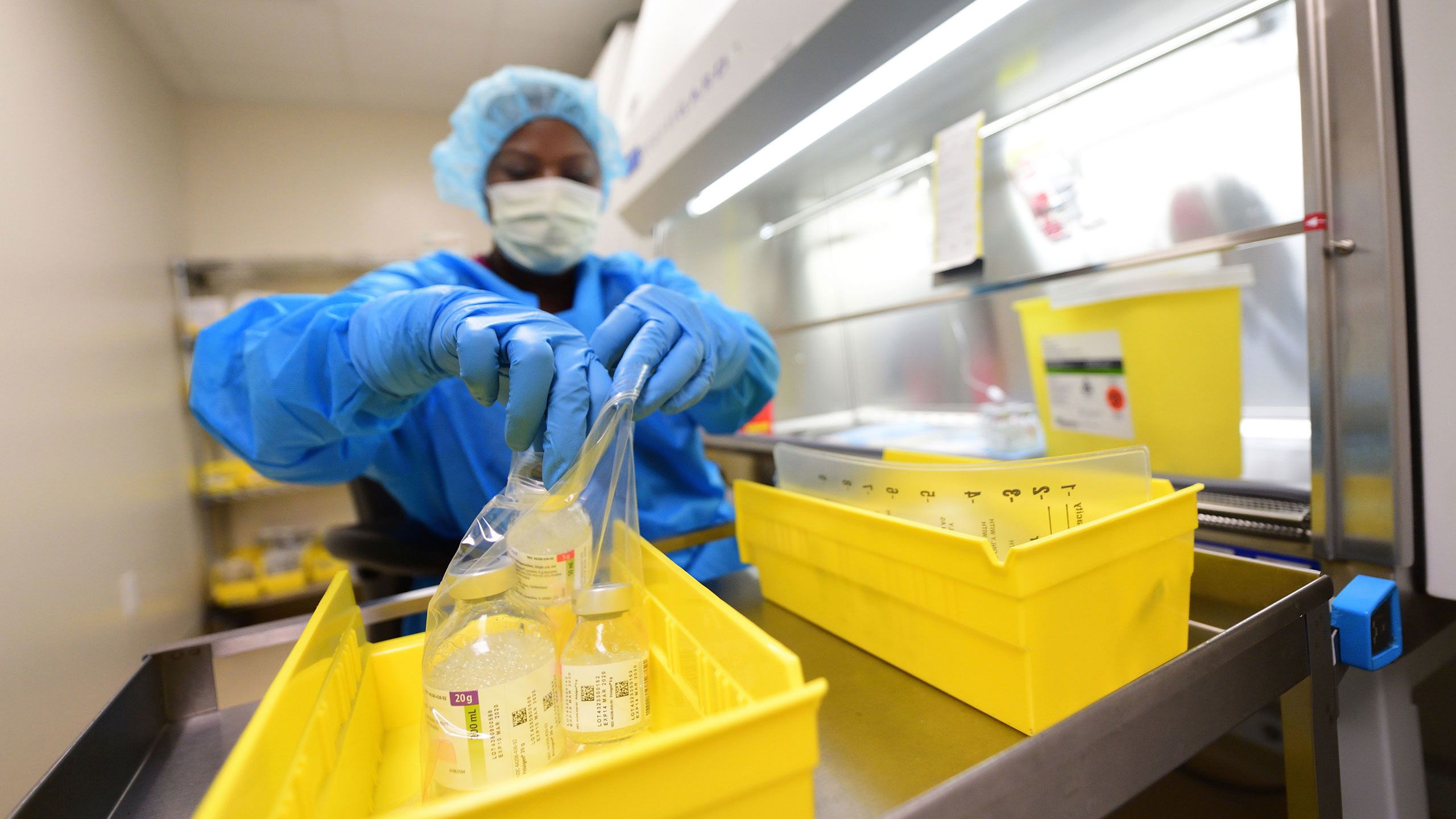 Pharmacy technicians who mix precise doses of medicines for each individualized prescription