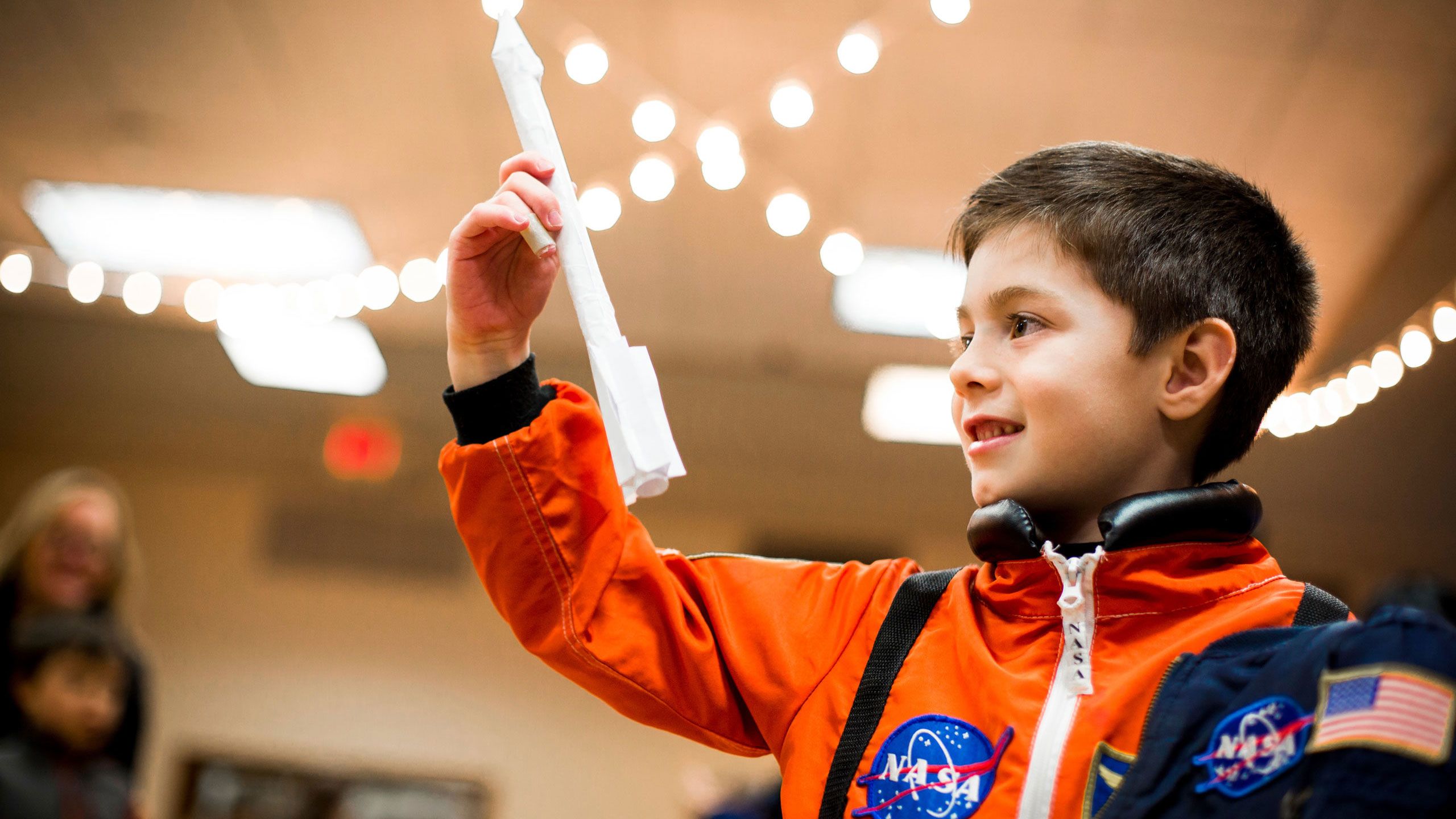 A young boy plays with a paper rocket as Emory hosts the Atlanta Science Festival opening event, featuring astronaut Mark Kelly.