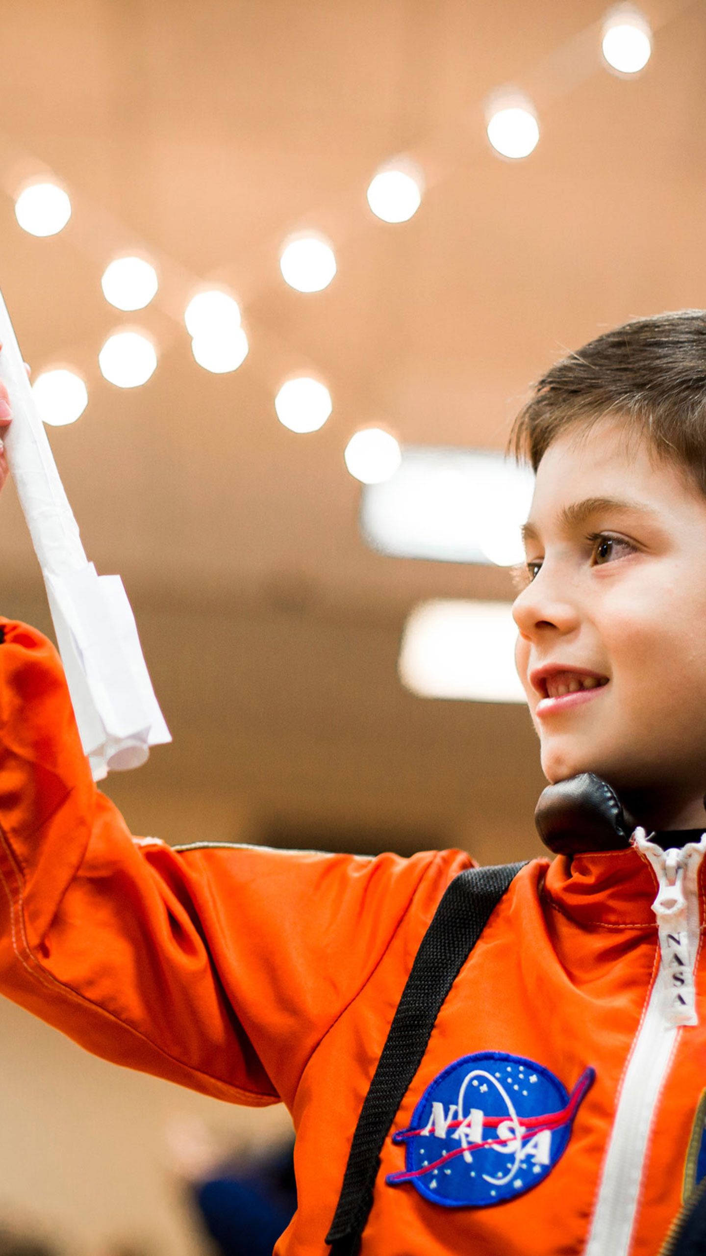 A young boy plays with a paper rocket as Emory hosts the Atlanta Science Festival opening event, featuring astronaut Mark Kelly.