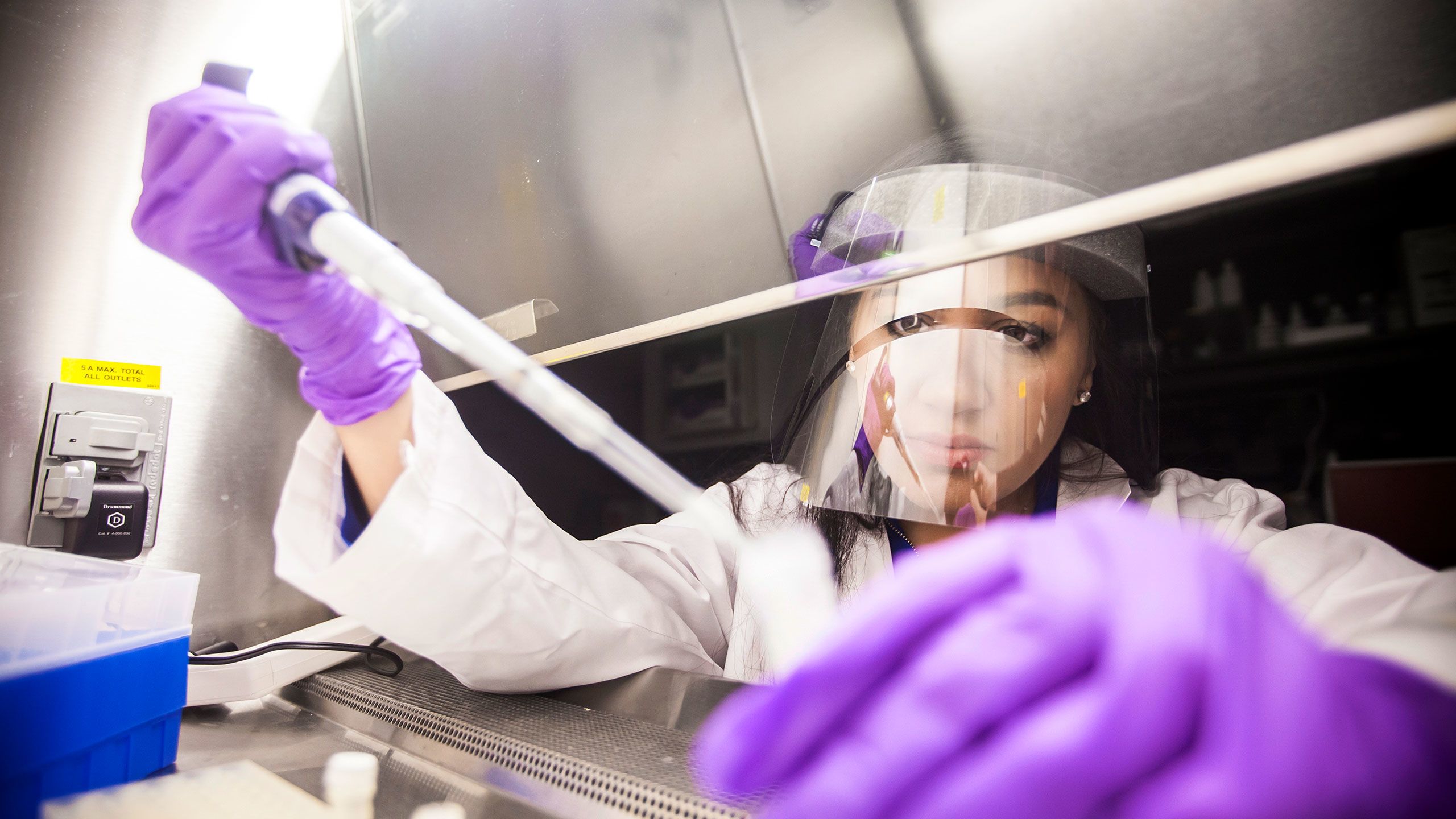 Alexa Dantzler wears protective gear while working in a science lab.