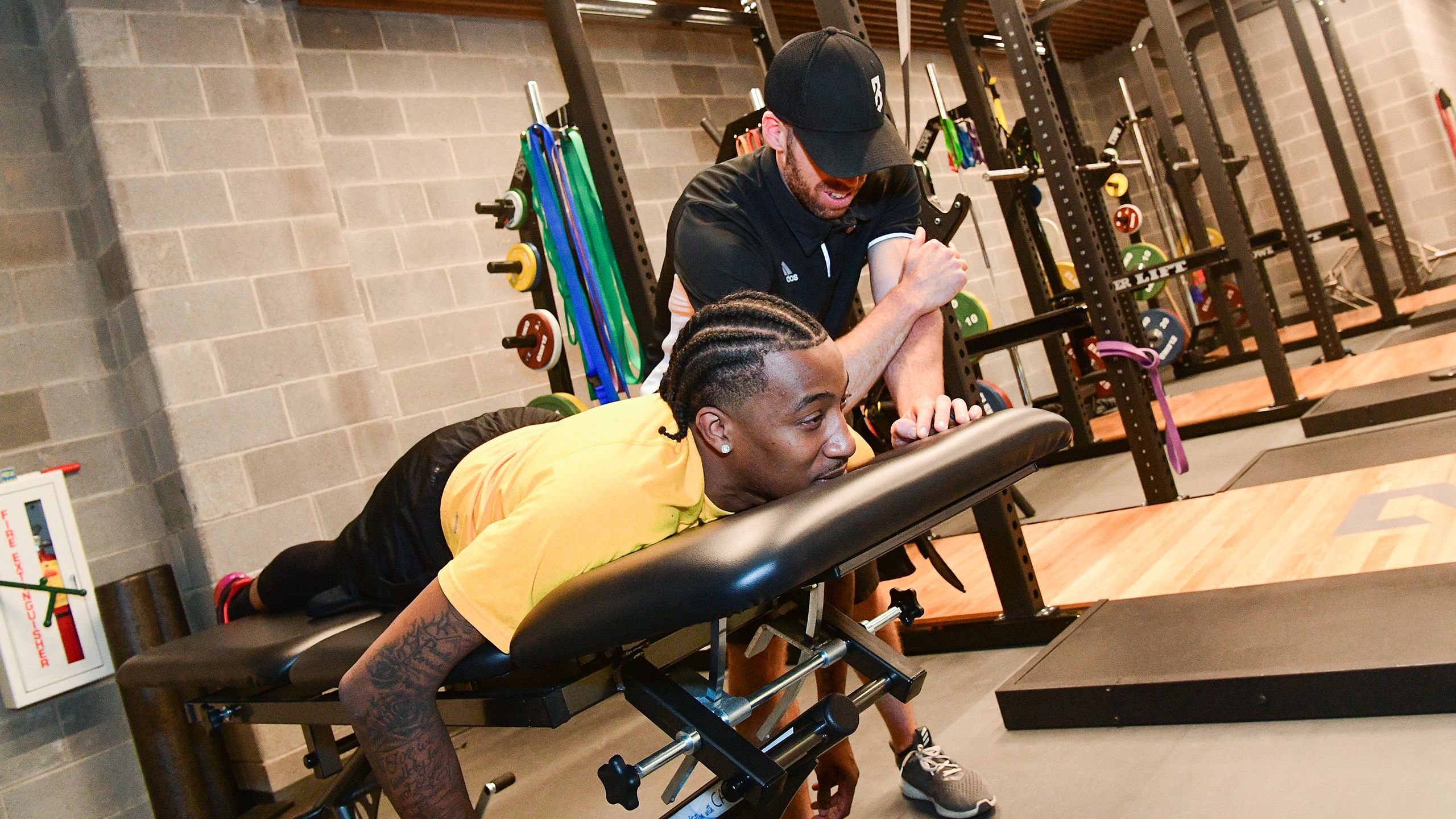 NBA basketball player Jordan McRae is being massaged by a P3 trainer.