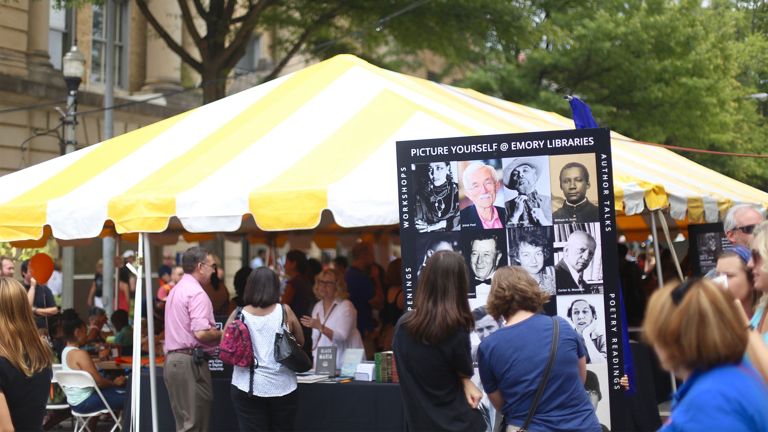 A crowd surrounds the Emory University tent at the Decatur Book Festival.