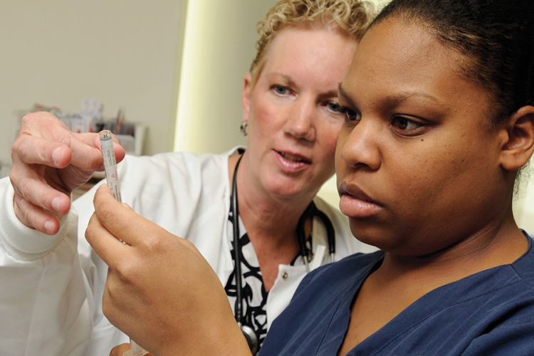 A nursing instructor with a student.