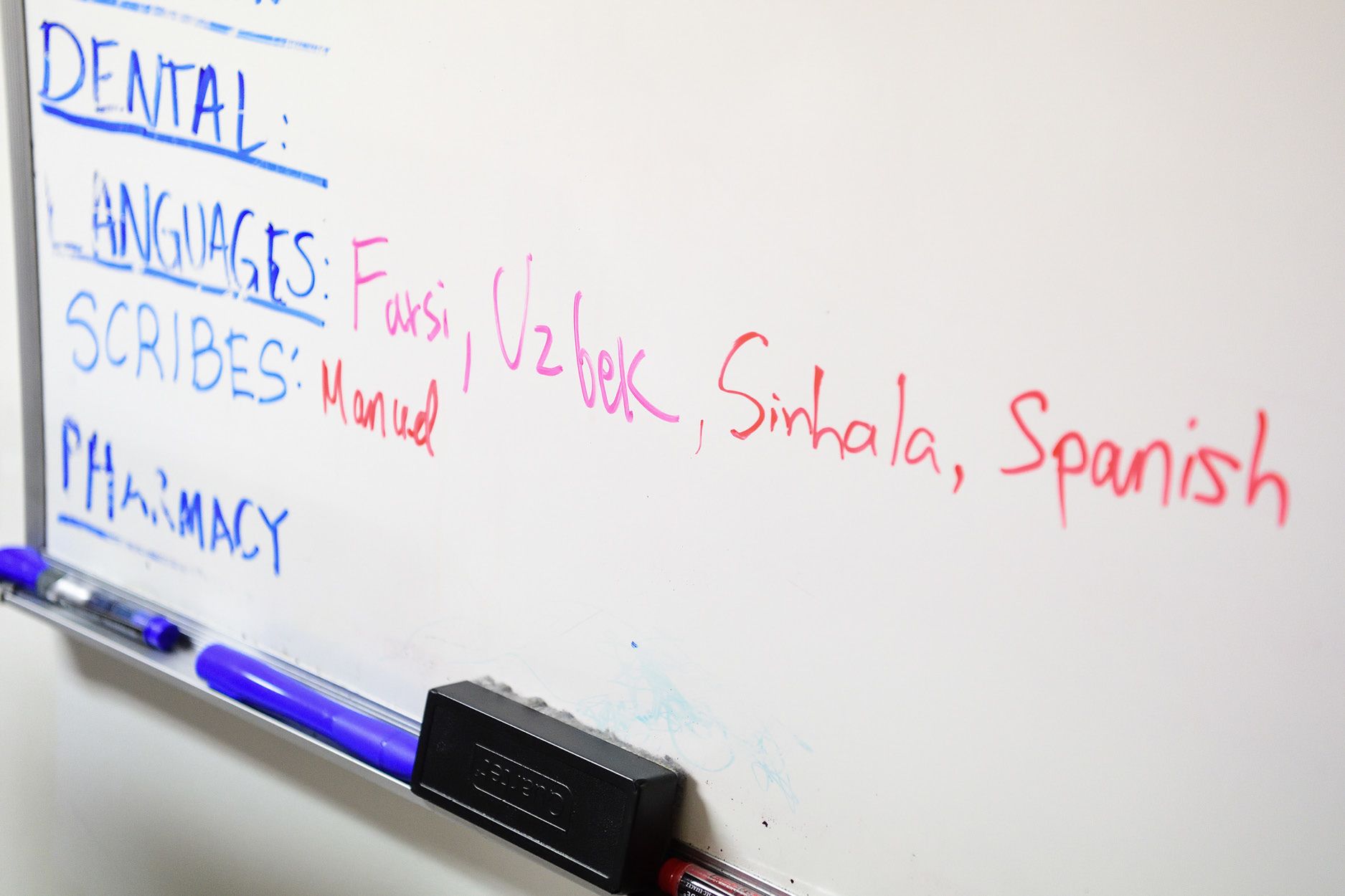 A white board shows all the languages spoken by patients at Clarkston clinic and the need for interpreters.