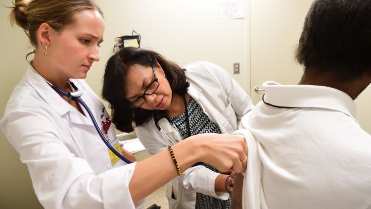 Emory medical student examines a patient at Gateway Clinic.