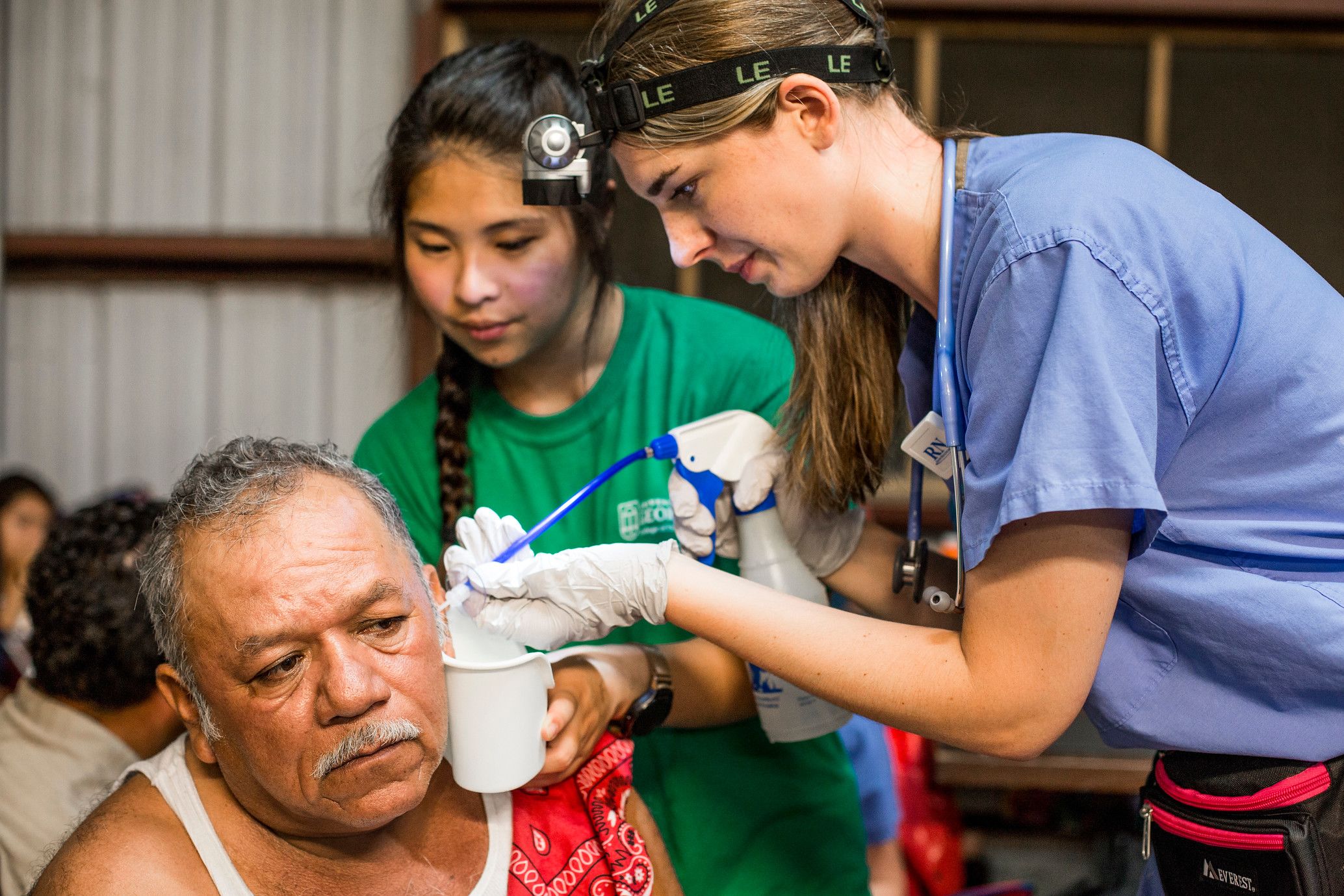 Two Emory nursing students work with a patient