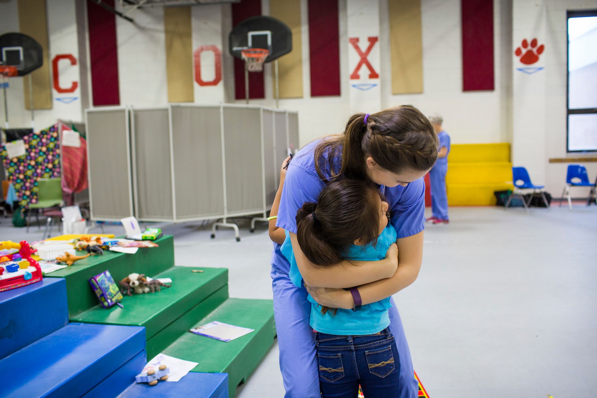 An Emory nursing student hugs a child