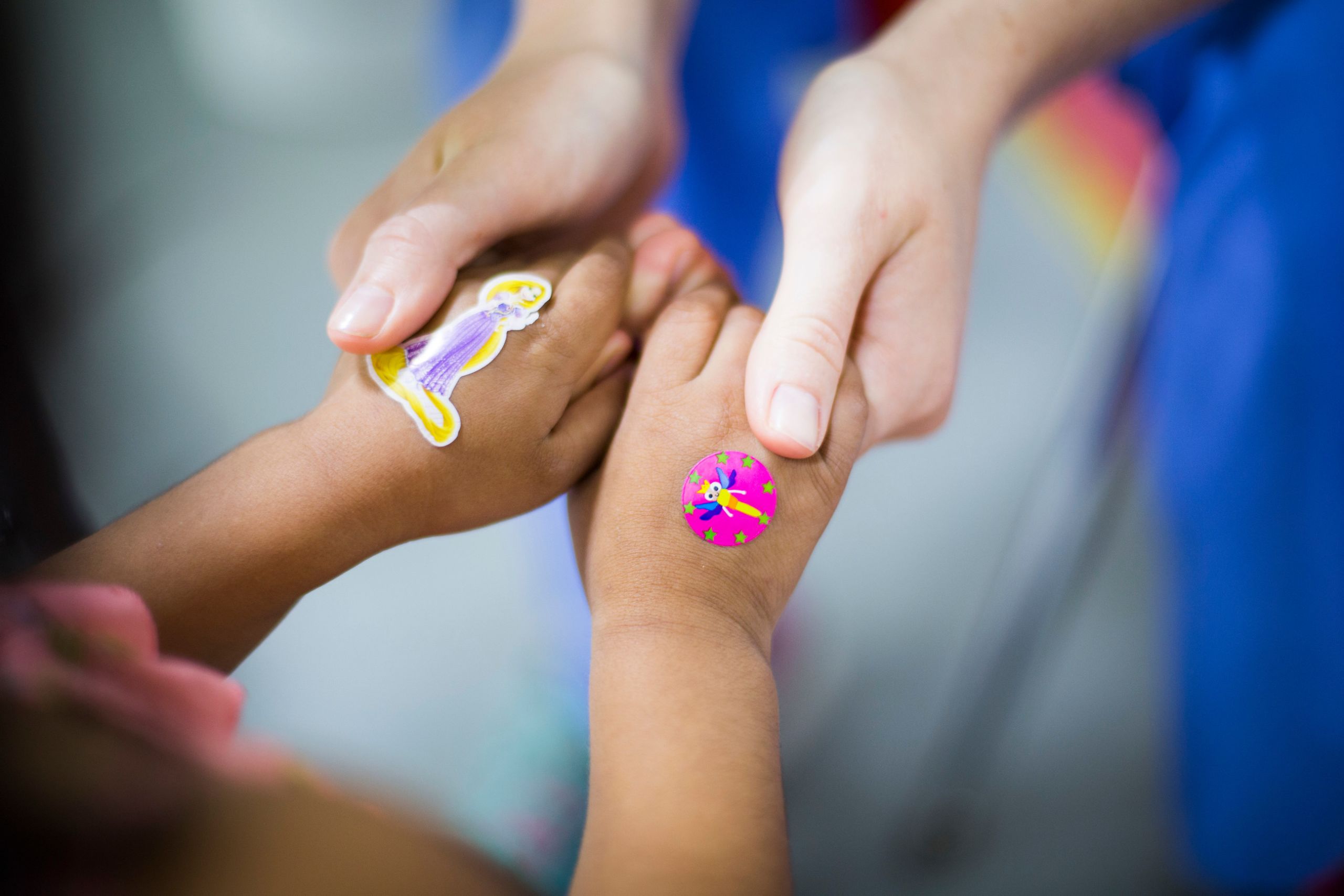 A child wears stickers on her hands