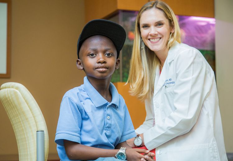 Young children like the 8-year-old boy seen here need doctors who specialize in how to treat cancer in children. 