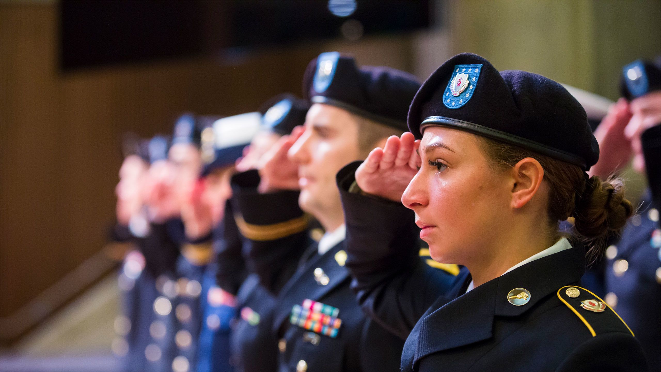 Students in uniform salute during Emory's 2018 Veterans Day Ceremony.
