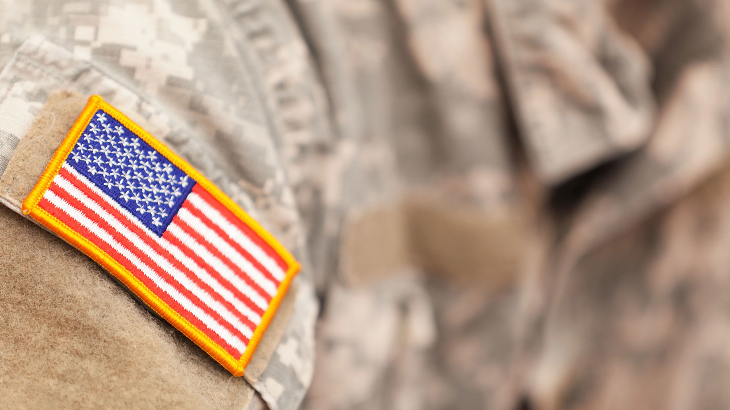 An American flag patch on a camoflauge uniform