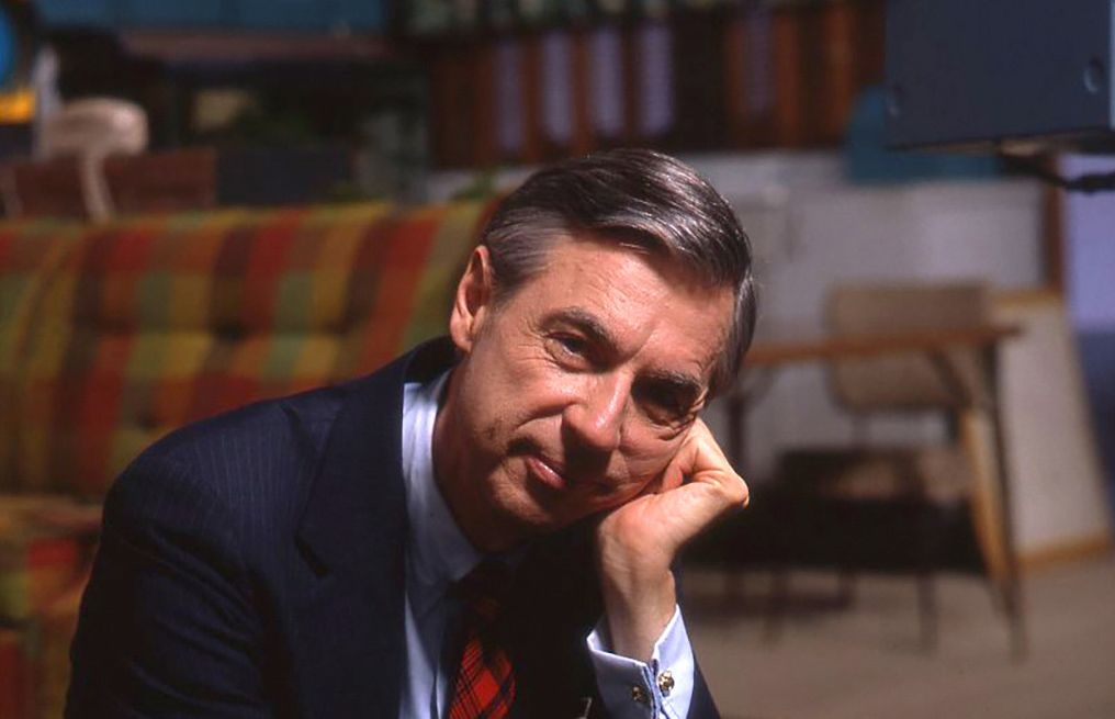 Fred Rogers sits with his head resting on his hand.