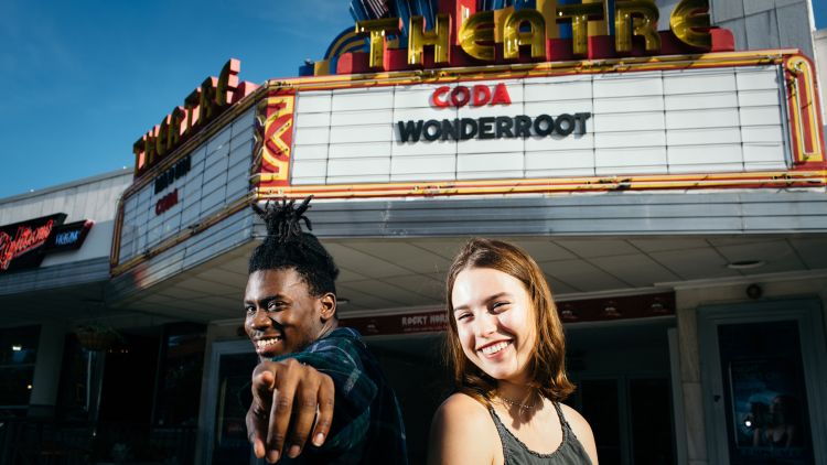 Two students pose in front of the Plaza Theatre in Atlanta