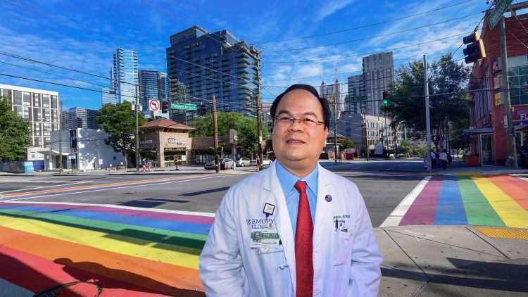 Dr. Vin Tangpricha poses in front of the rainbow crosswalks in midtown Atlanta