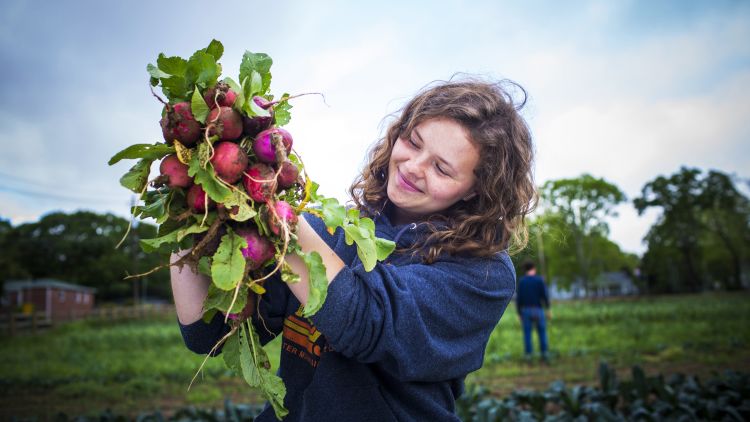 A student works on the farm at Oxford College