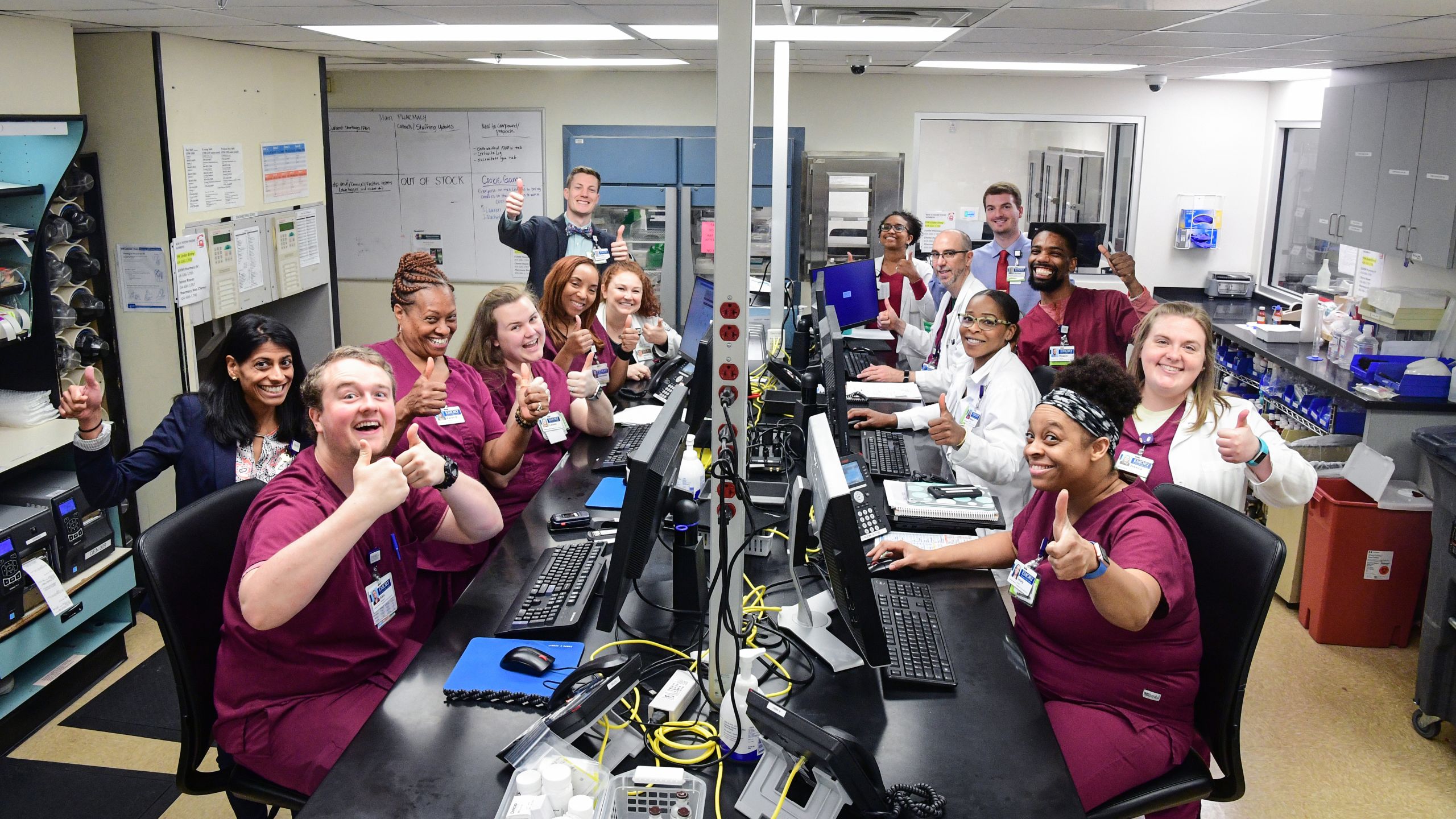 An image of the pharmacy staff and trainees taking a happy group photo