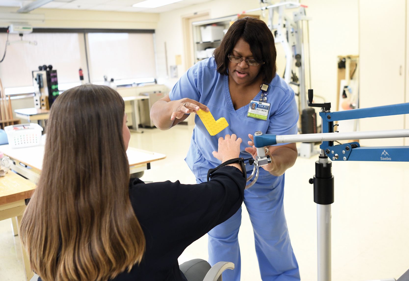 image of occupational therapist Beth Terrell working with a patient in a rehab room.